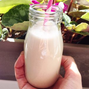 Banana protein shake in a small milk bottle