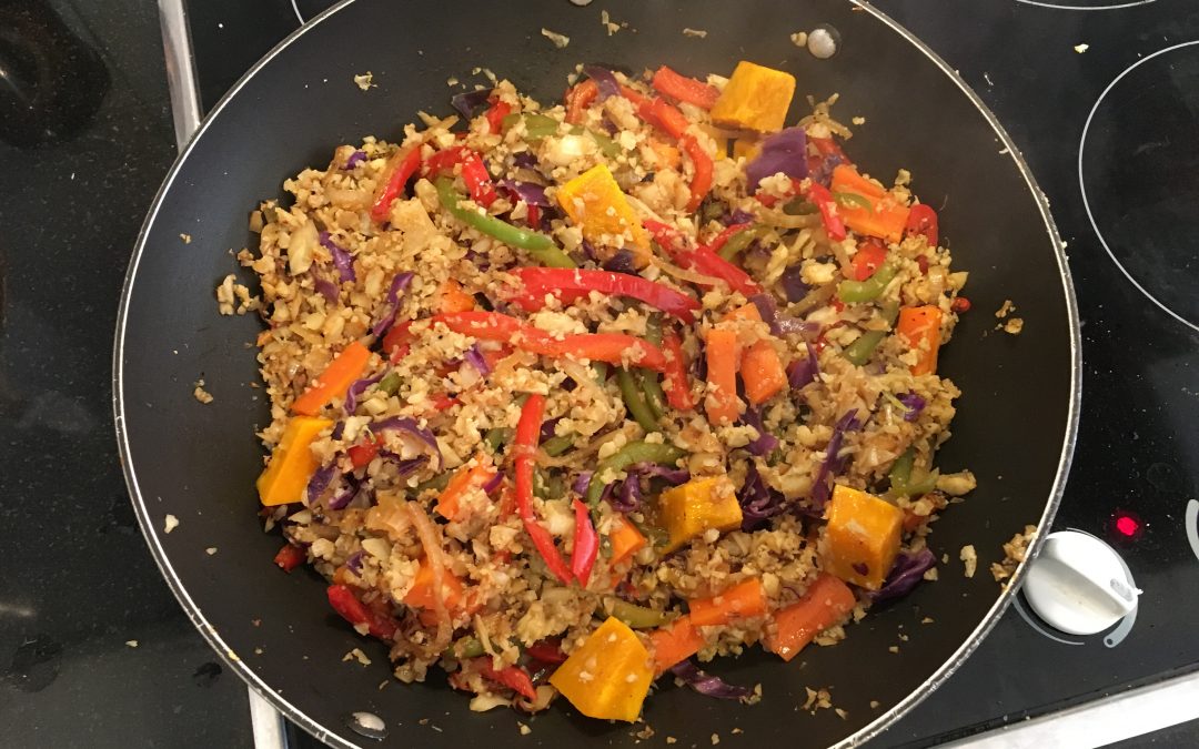 Cauliflower fried rice being cooked in a wok 2