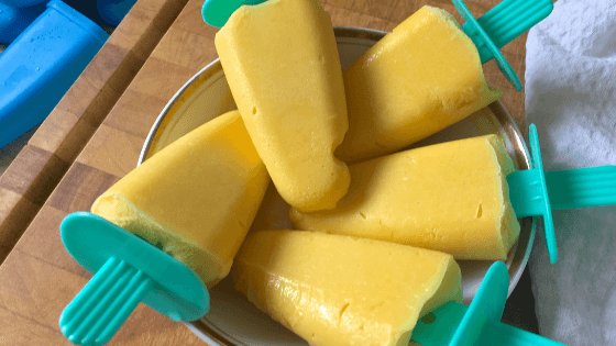 Mango ice cream popsicles in a bowl