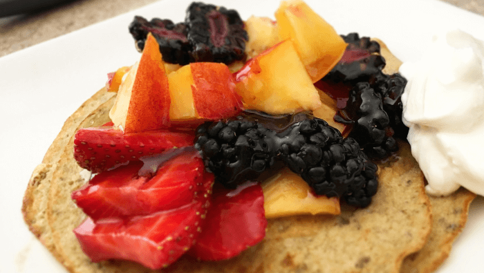 close up of pancakes with fresh fruit and Greek yoghurt