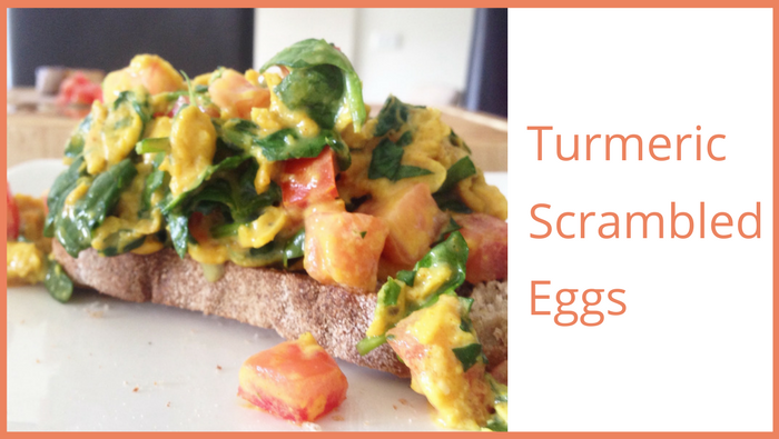 Turmeric scrambled eggs with spinach and tomatoes