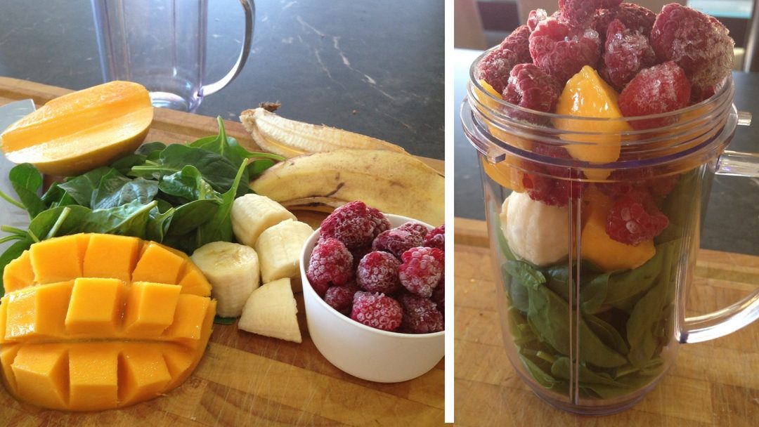 Easy green smoothie ingredients: mango, raspberries, banana & spinach on chopping board blog header