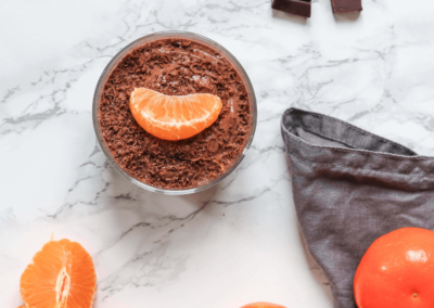 Vegan orange chocolate mousse in a glass with orange slices for decoration
