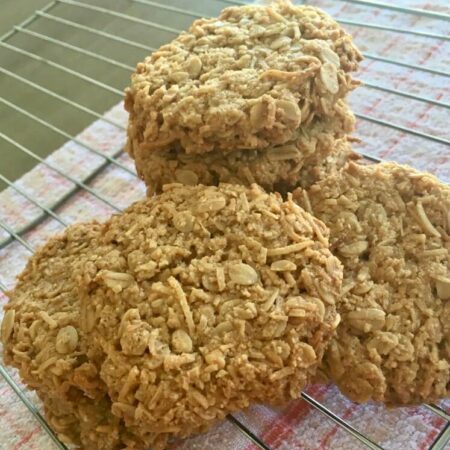 Close up of Anzac biscuits on a cooling rack