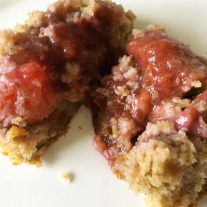 The inside of a rhubarb muffin showing the runny fruity centre