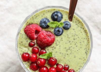 a bowl of matcha chia pudding, topped with berries