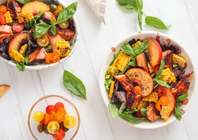 salmon and peach salad in bowls