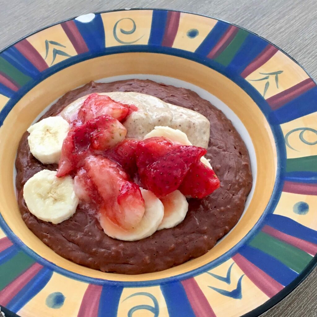 Choc nut butter porridge with banana and strawberries