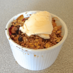 Fruit crumble in a ramekin on the kitchen bench
