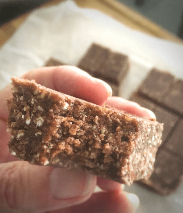 A peanut butter energy bar in close up, with a bite taken out