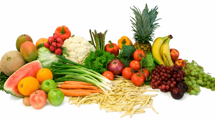 fresh fruit and vegetables laid out on a table