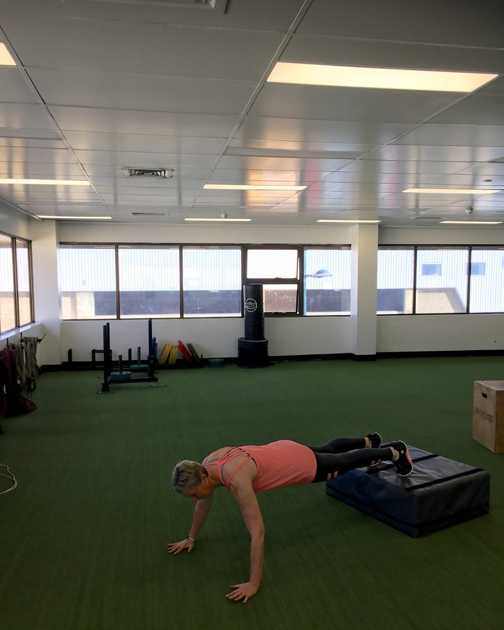 Wendy doing decline pushups with elevated on a box
