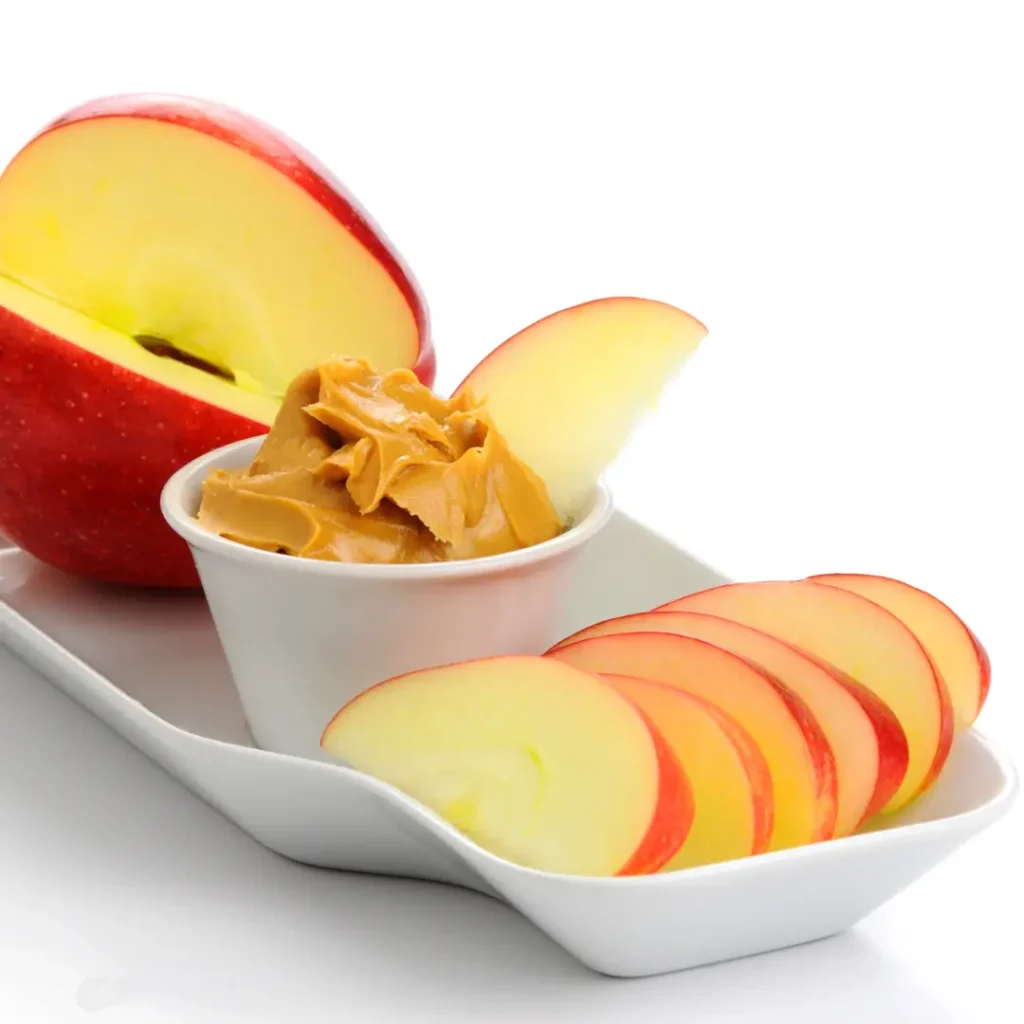 Plate of apple slices with a peanut butter dipping pot