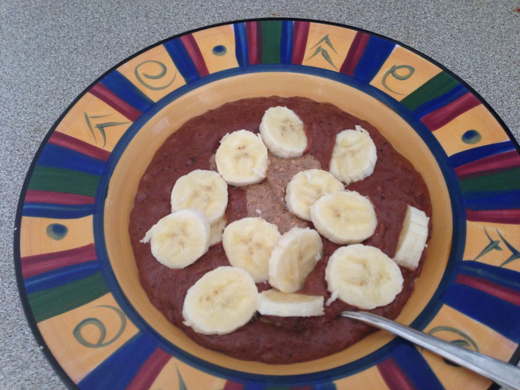 choc nut butter porridge topped with banana in a bowl