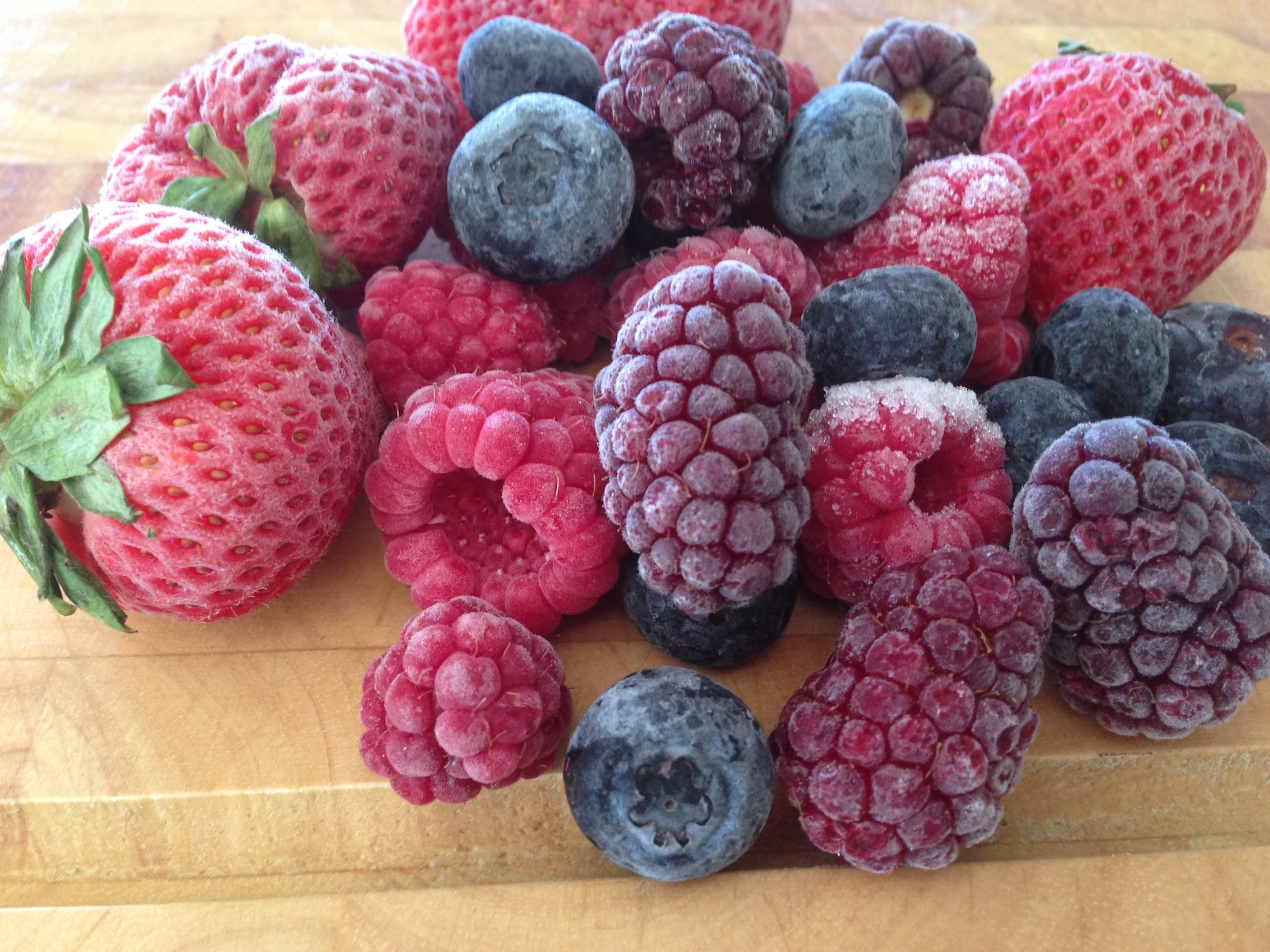 Closeup of mixed berries on a chopping board