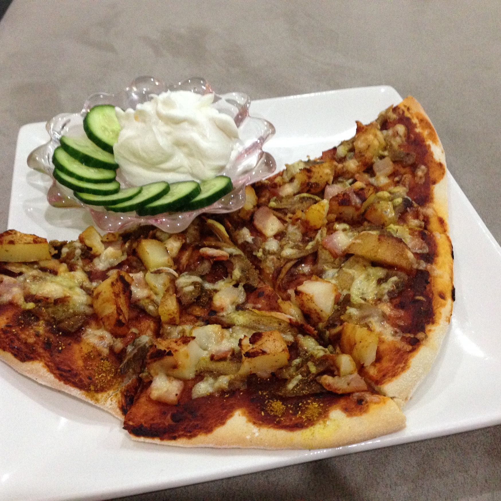 home made pizza with cucumber and yoghurt dip