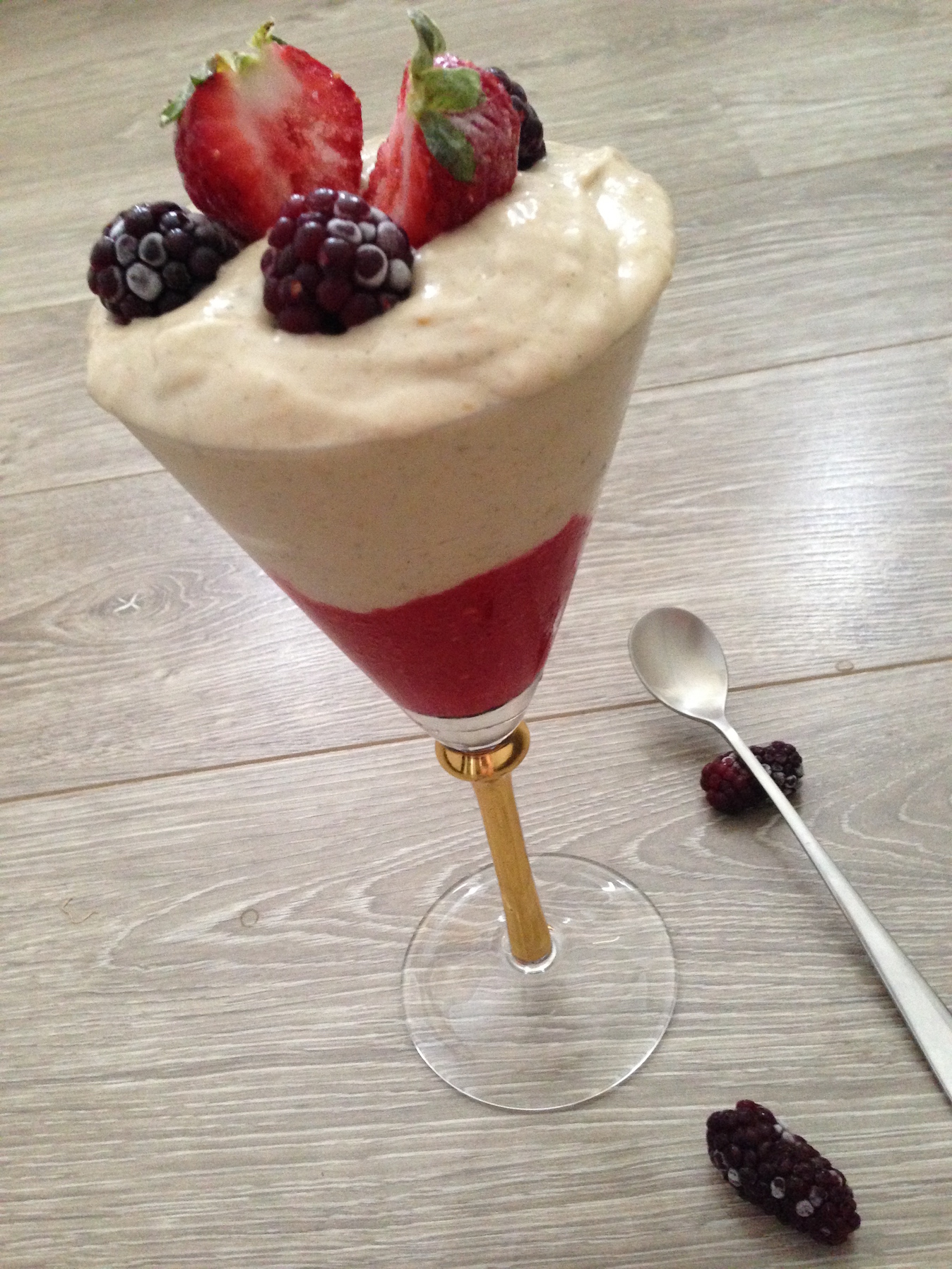 banana and berry nice cream layered in a fancy glass