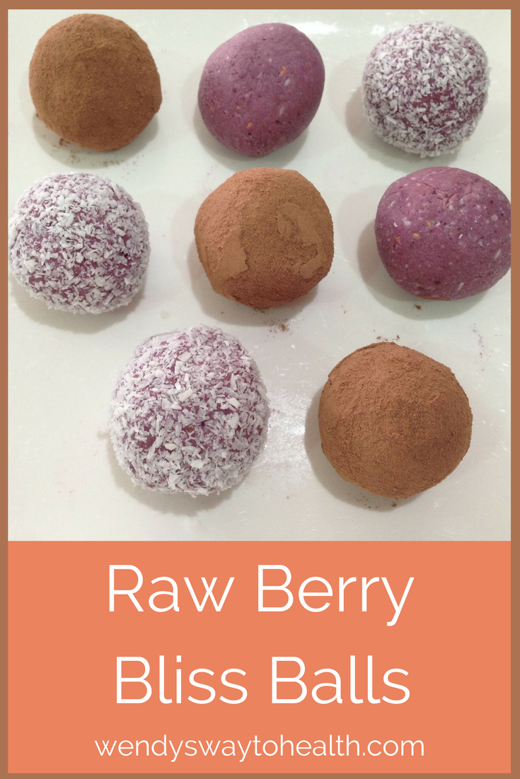 Pin image of raw berry bliss balls on a plate
