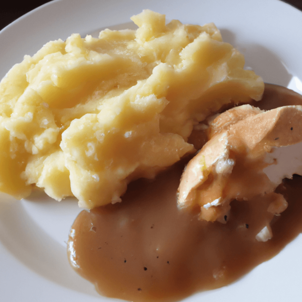 chicken mashed potato and gravy on a plate