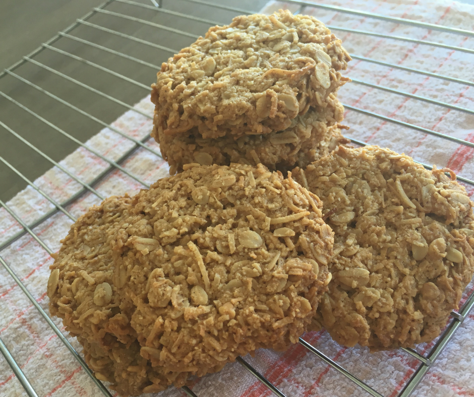 A pile of Anzac biscuits cooling on a rack