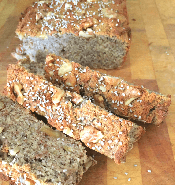 Banana bread loaf cut into slices on a chopping board