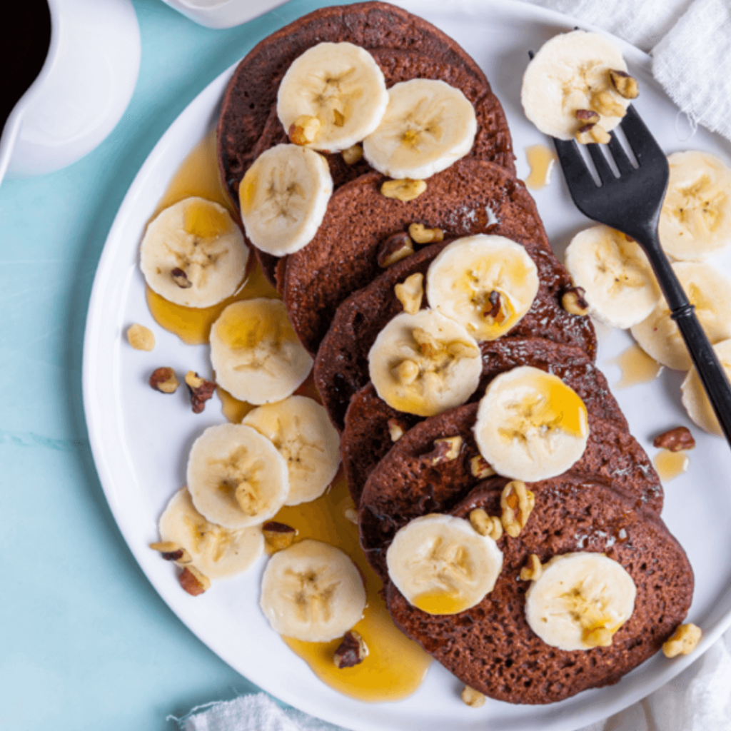 Chocolate protein pancakes topped with sliced banana 