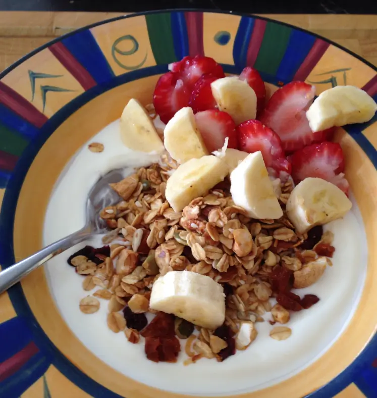 Yoghurt bowl topped with fruit and toasted muesli