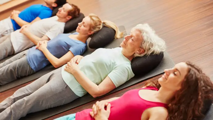 Group of women lying on yoga mats